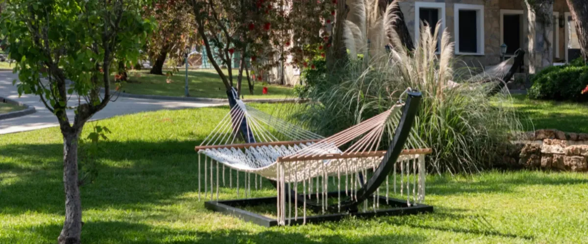 Backyard hammock set up in a landscaped garden for outdoor relaxation.