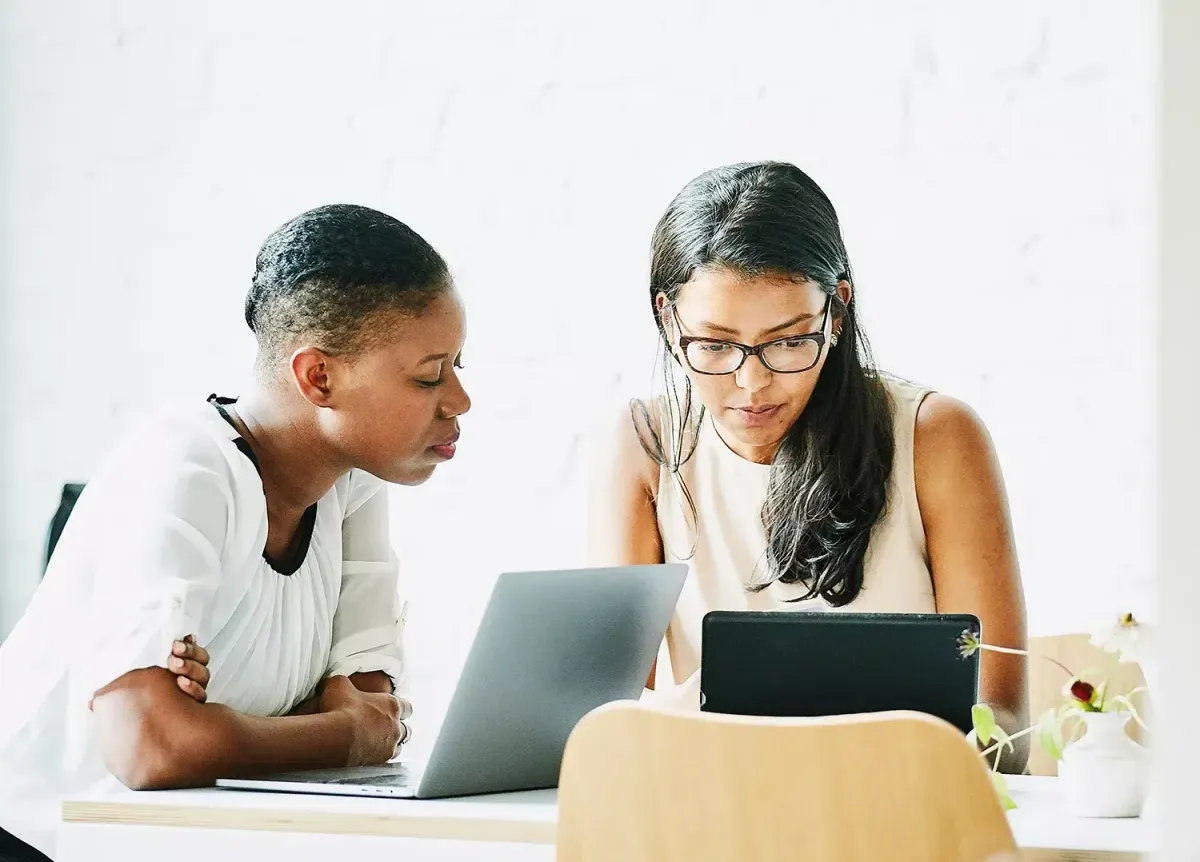 Businesswomen collaborating on global business projects with a laptop