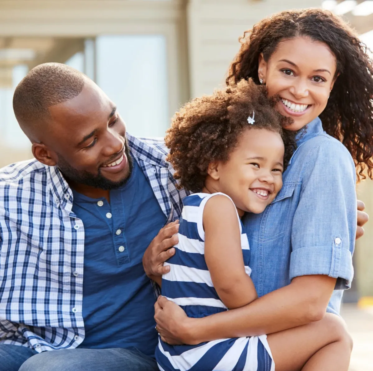 Woman holds a bag and a computer.