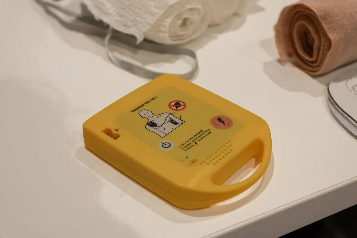 AED training unit and bandages ready for a workplace first aid drill