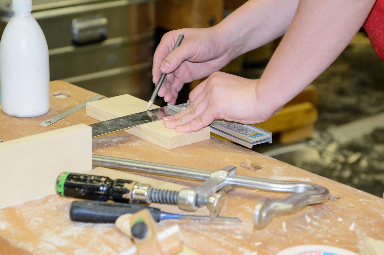 Carpenter measuring timber at a workbench