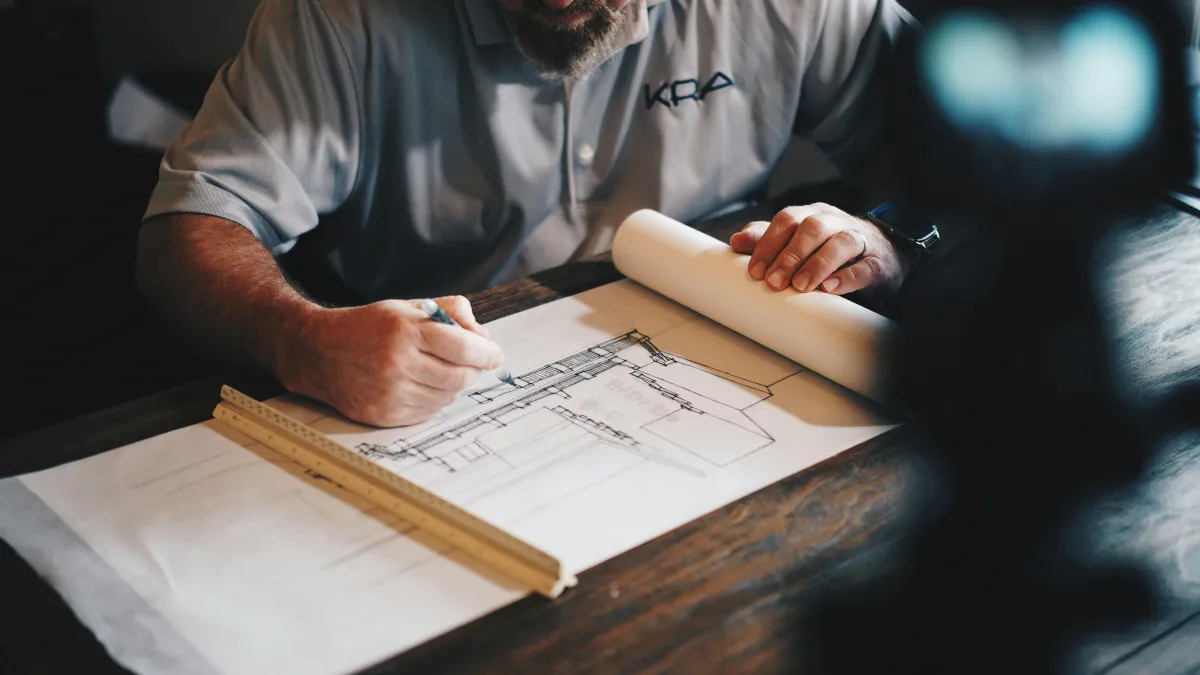Builder reviewing plans at a desk
