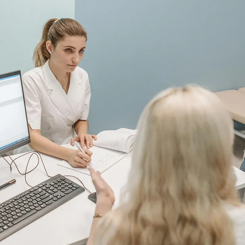 image of doctor examining a patient to represent healthcare and health insurance