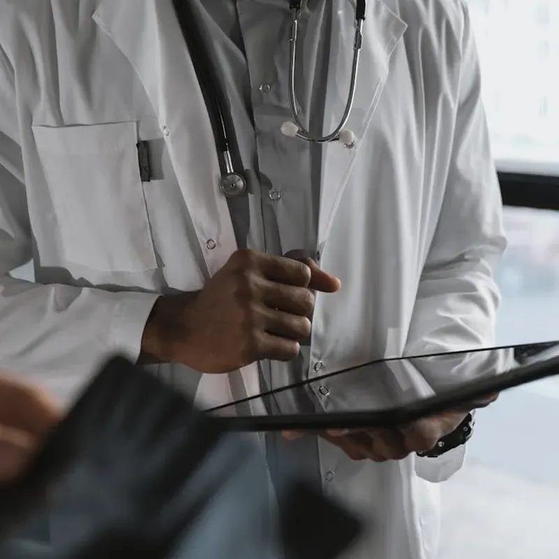 image of doctor examining a patient to represent healthcare and health insurance