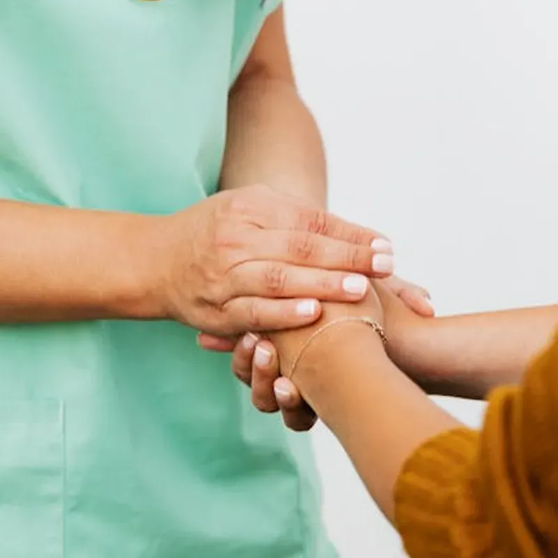 family posing and smiling for the camera infront of their home in the autumn