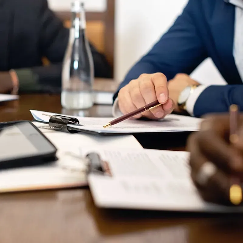 family posing and smiling for the camera infront of their home in the autumn