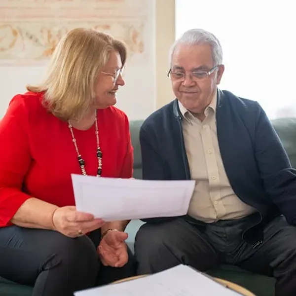 mature couple examining paper work related to medicare