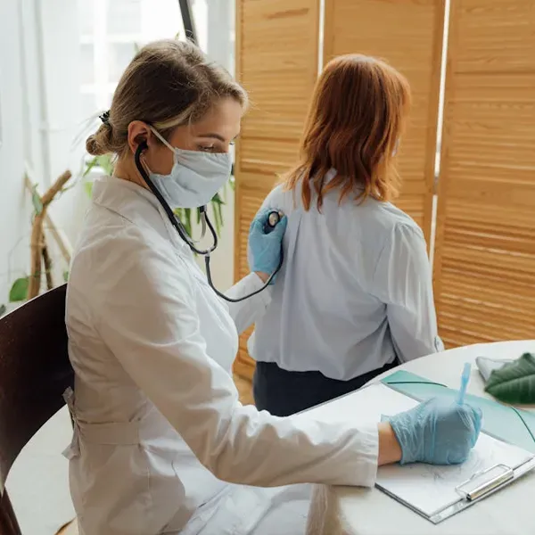 image of doctor examining a patient to represent healthcare and health insurance