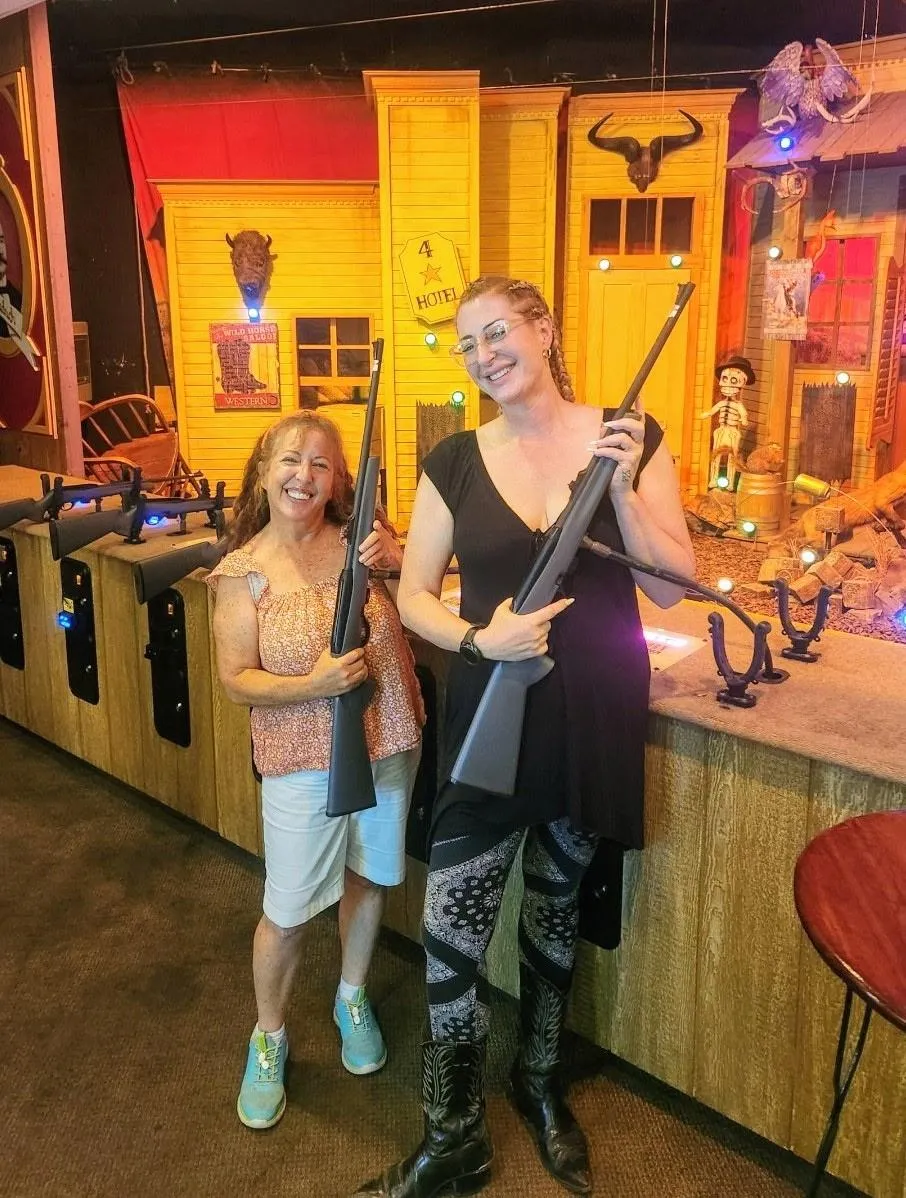 Two women posing after a shooting gallery