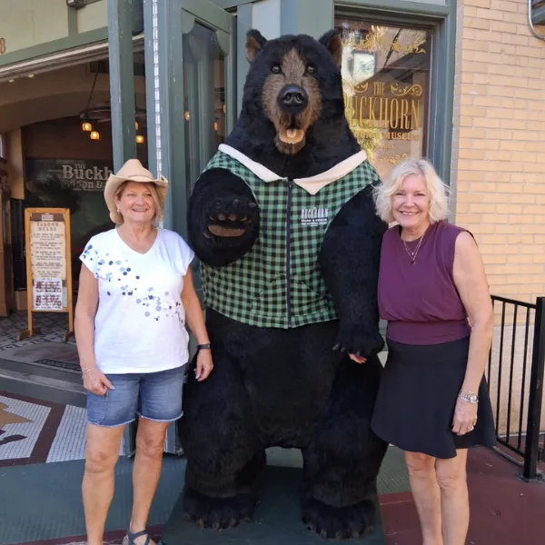 Standing outside the Buckhorn Saloon by the bear