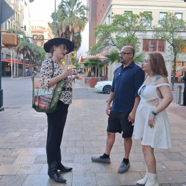 tourists listen to tour guide on walking tour