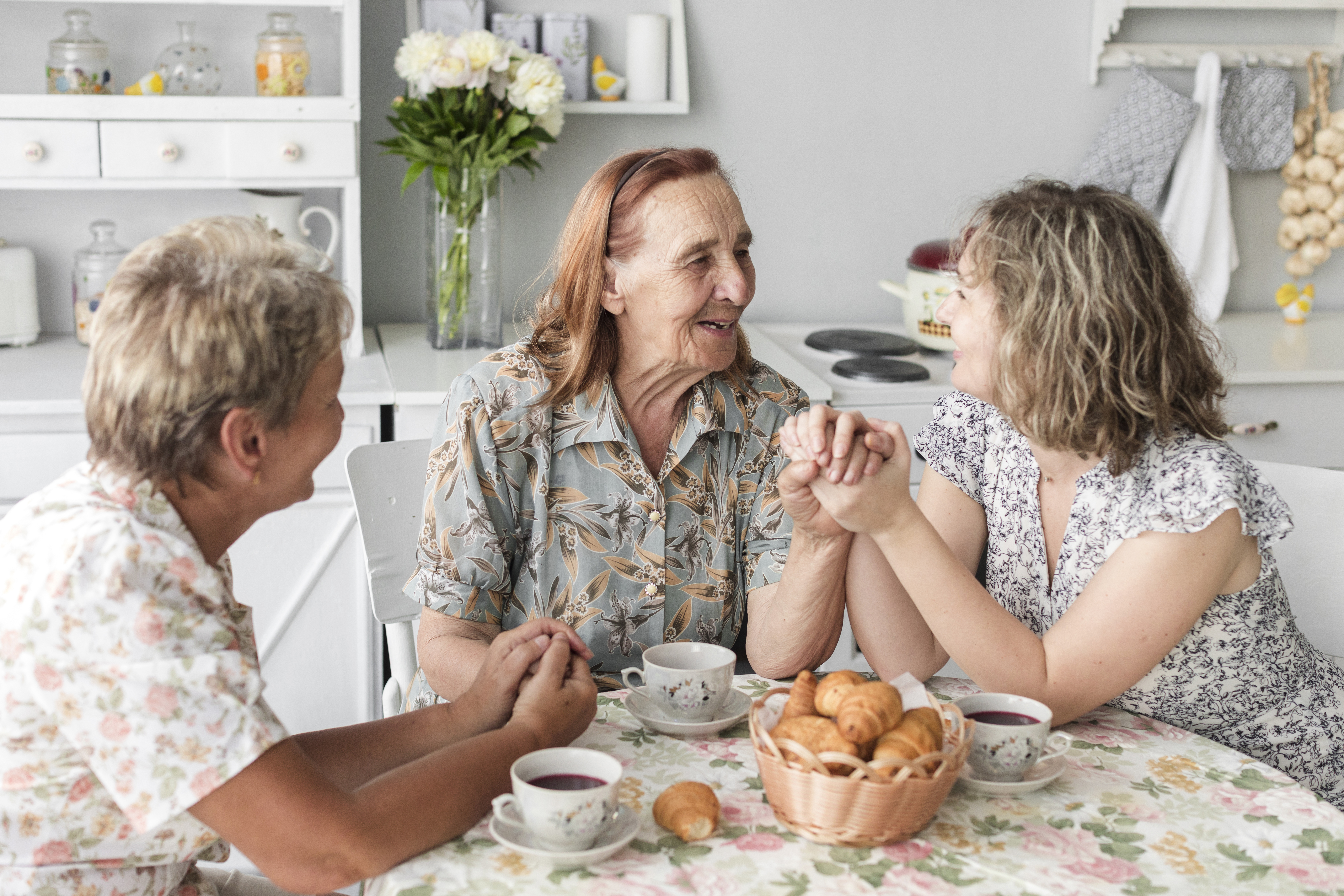A caregiver sharing a warm, reassuring conversation with their aging parent