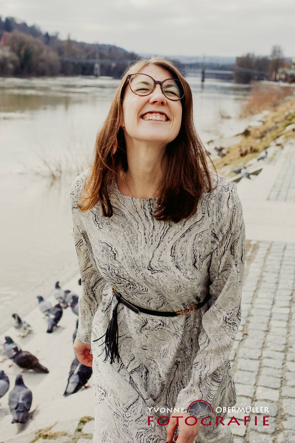 Personal Branding Porträt in Schwarz-Weiß: Selbstbewusste Unternehmerin im weißen Anzug vor einer rustikalen Steinmauer