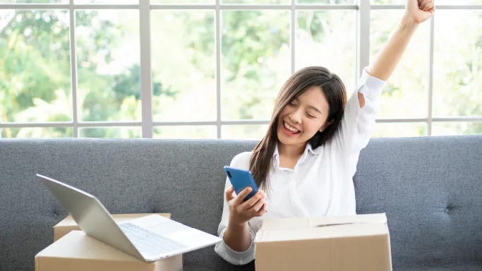 Happy home seller packing her belongings 