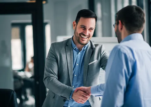 Home Buying Agent shaking hands with a home owner 