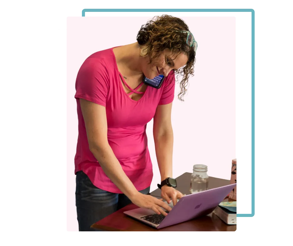 Mandy McGowan working on a laptop at a desk, focused on organizing business finances