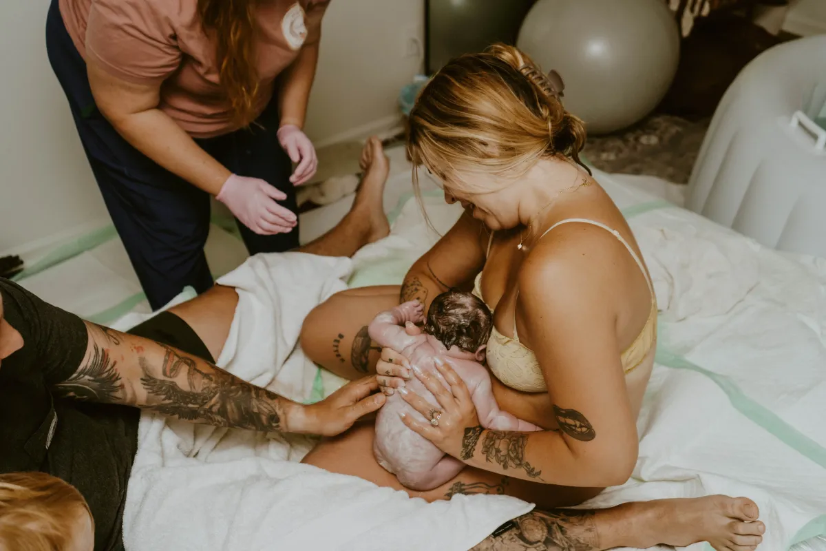 Mother and newborn receiving support immediately after home birth