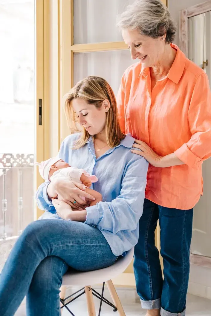 Mother holding her newborn while receiving postpartum support in Forsyth, GA
