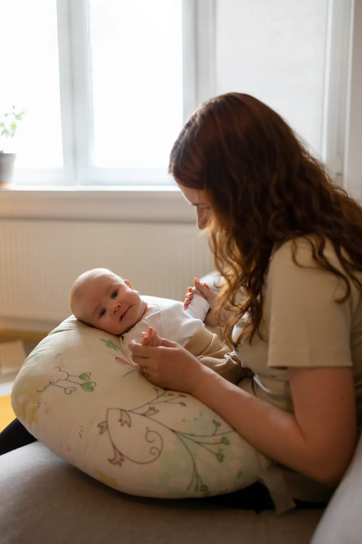 Mother caring for newborn baby during postpartum support and home birth care in Peachtree City, GA