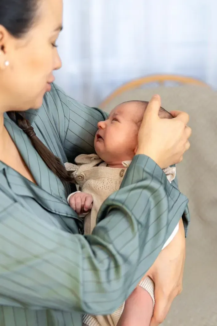 Mother holding newborn baby after natural birth with postpartum support in Zebulon, Georgia