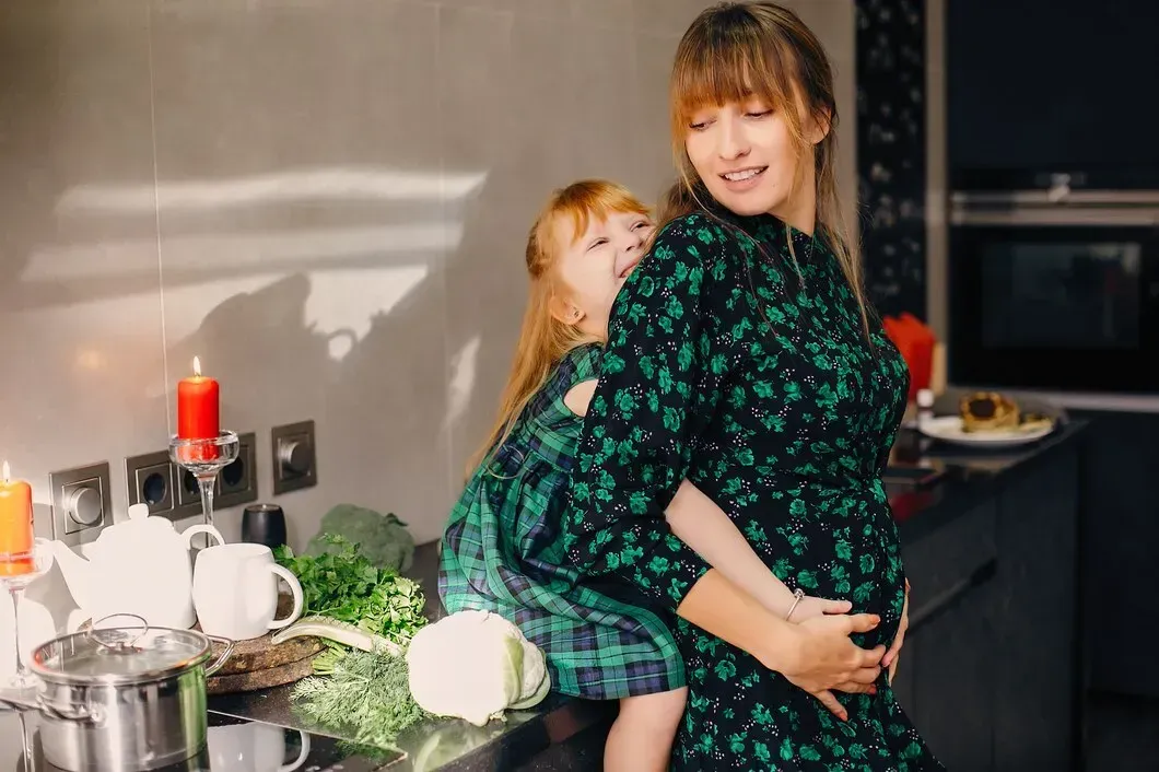Pregnant mother with her child at home in Thomaston, GA