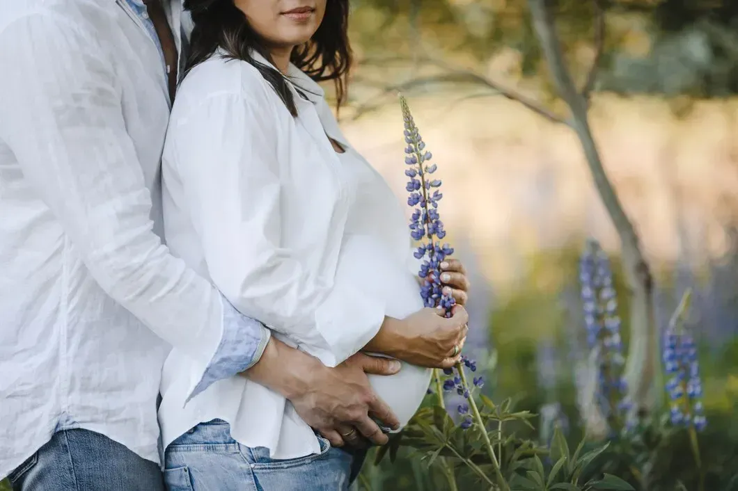 Pregnant woman with her partner outdoors in Macon, GA