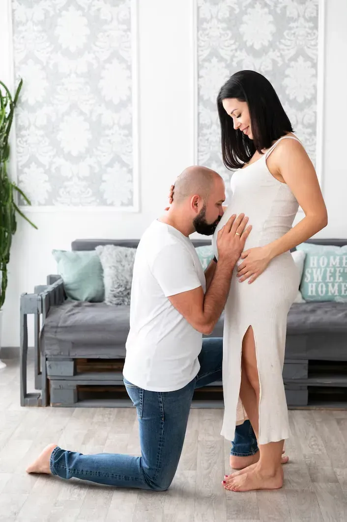 Pregnant woman receiving loving support from her partner in Forsyth, GA