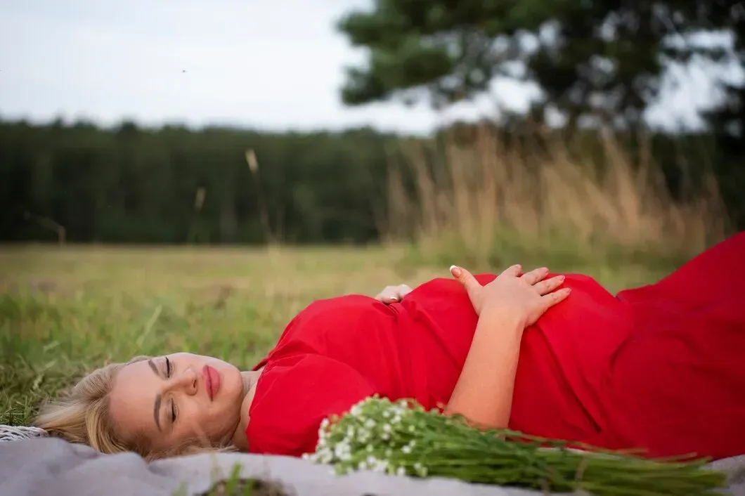 Pregnant woman relaxing outdoors during pregnancy in Griffin, GA