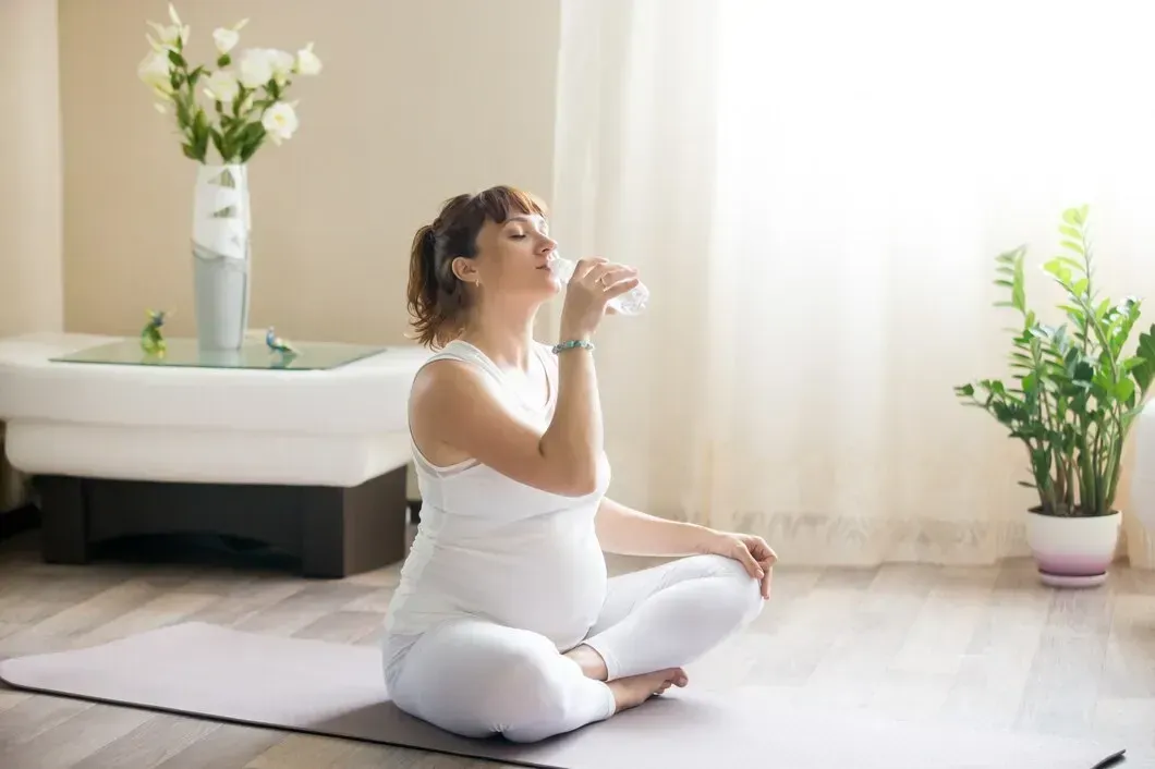Pregnant woman practicing calm holistic wellness care during pregnancy in Peachtree City, GA