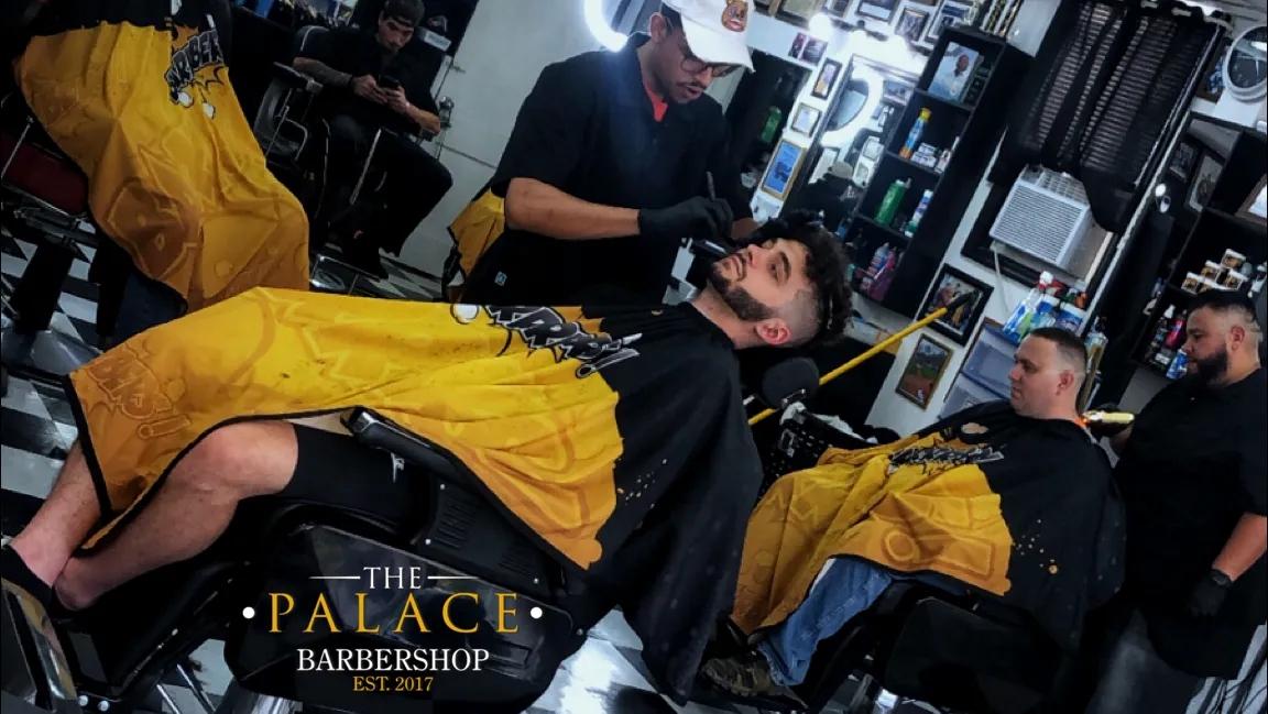 man in white dress shirt cutting hair of man in white dress shirt
