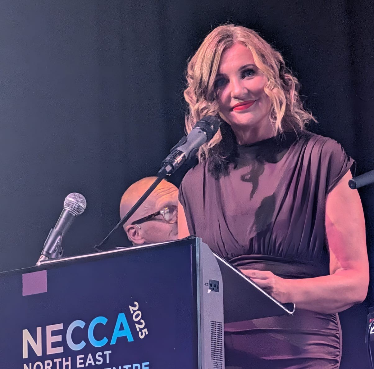 Julie Mordue, NECCA judge speaking on stage at the North East Contact Centre Awards