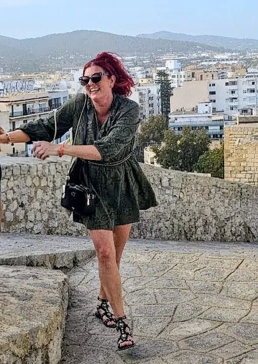 woman laughing as she struggles up hill
