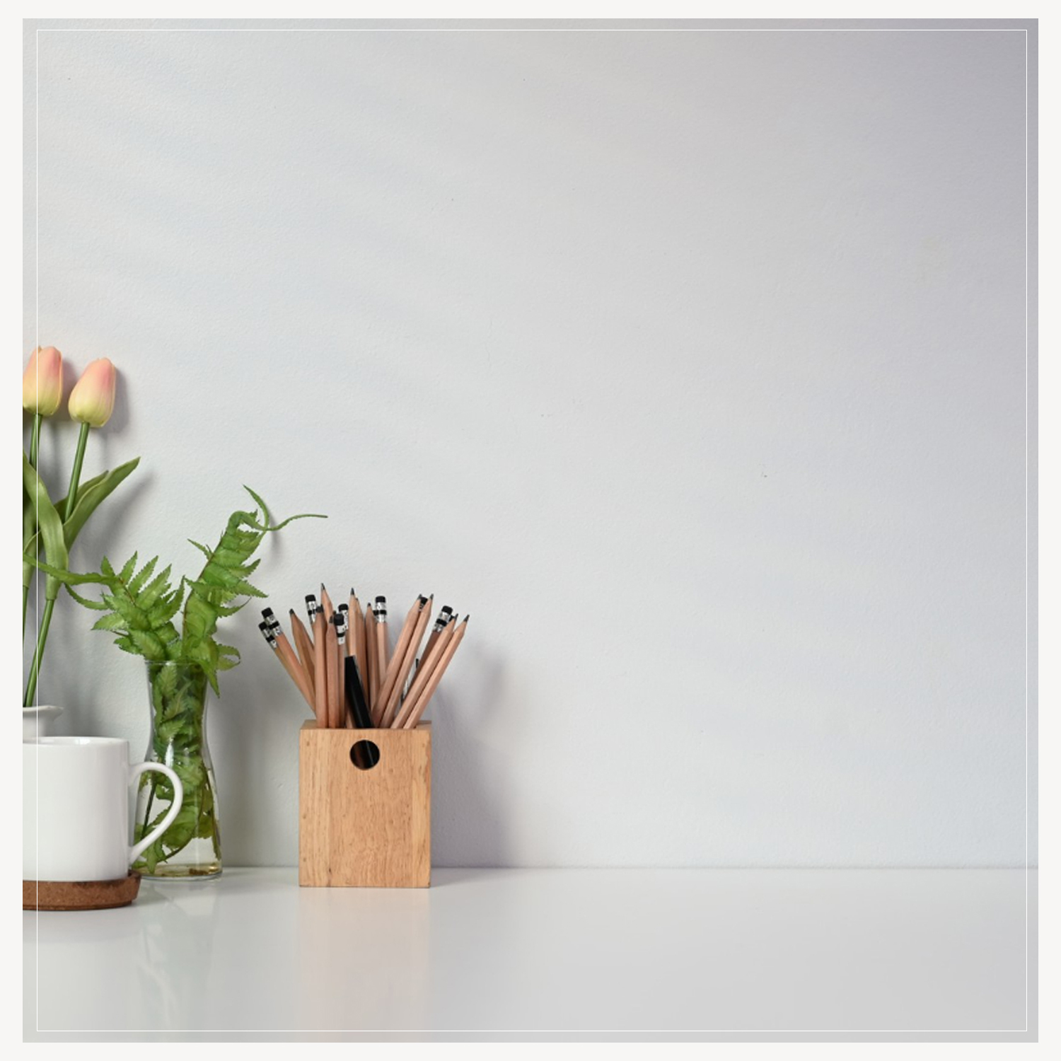 Desk with pencils and plant