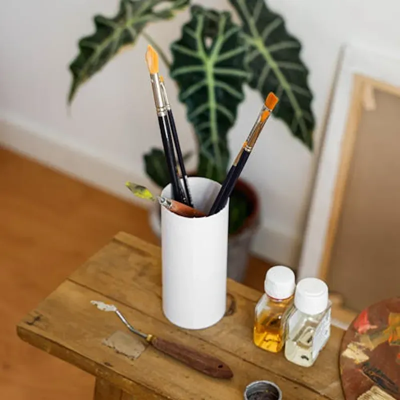 family posing and smiling for the camera infront of their home in the autumn