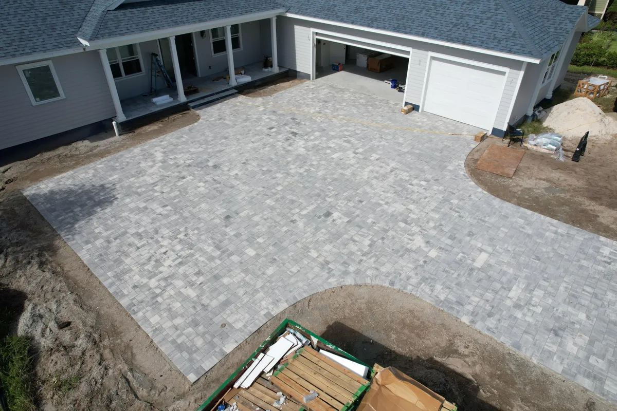 Completed gray paver driveway at Buma’s Marshside Drive project, photographed from above