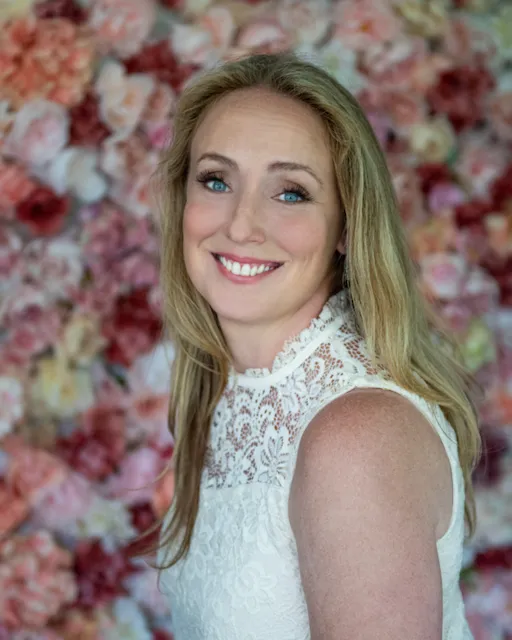 photo of Jorie Houlihan in a cream top with a flower backgro