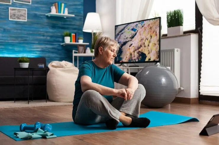 A woman performing a yoga pose on a mat, embodying grace and concentration in her exercise routine