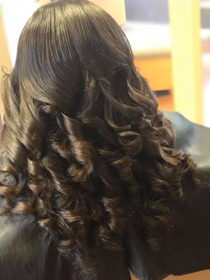 Young woman with long dark hair smiles