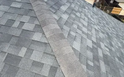 Shingle roof repair underway in Austin, TX with safety ropes and tools in position