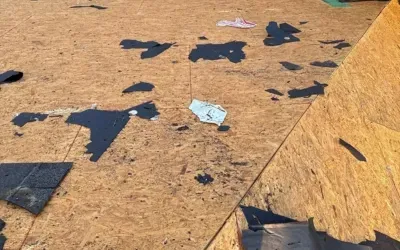 Severely damaged roof with collapsed sections in Liberty Hill, TX after storm impact