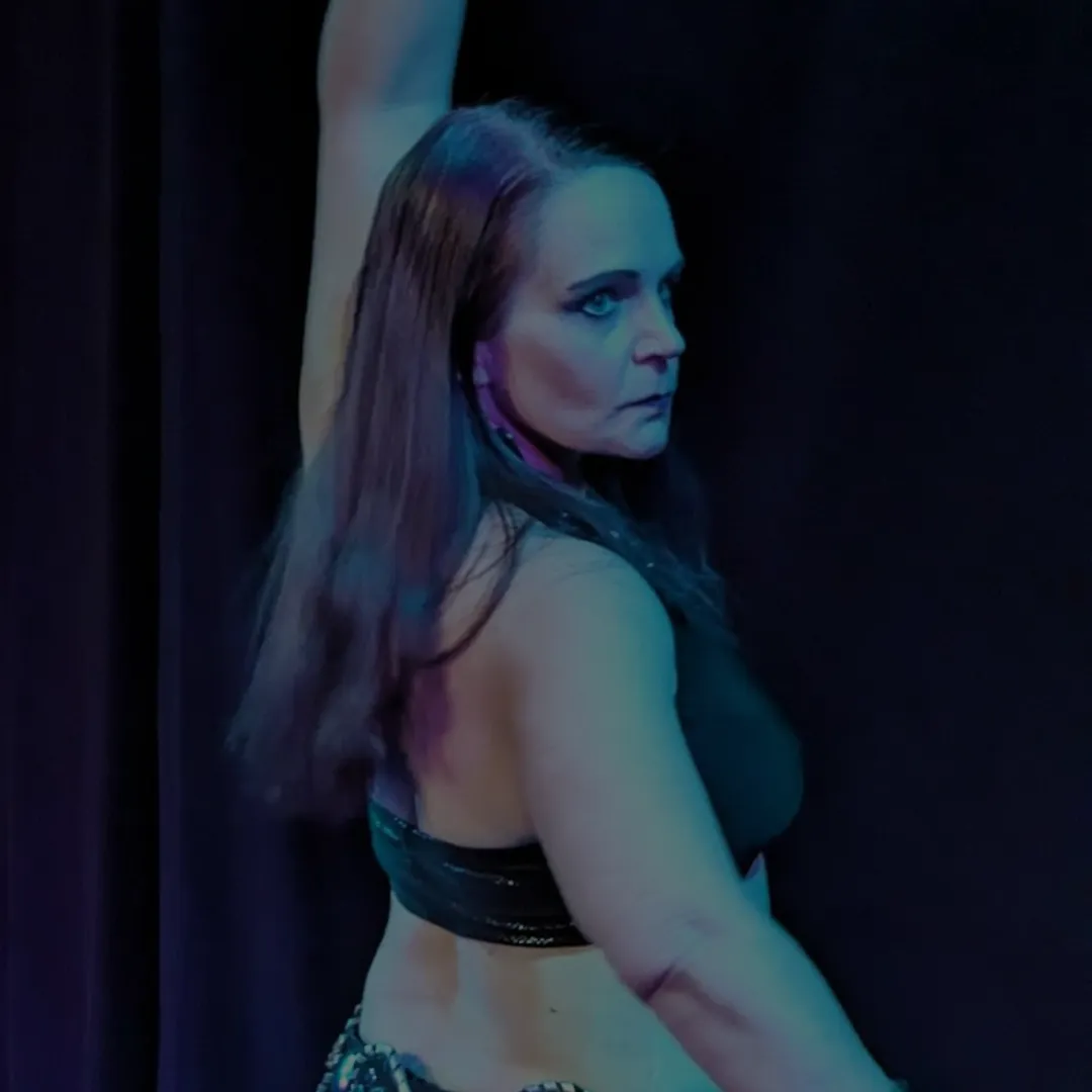 Aeryn dark fusion dancer posed for performance in black costume