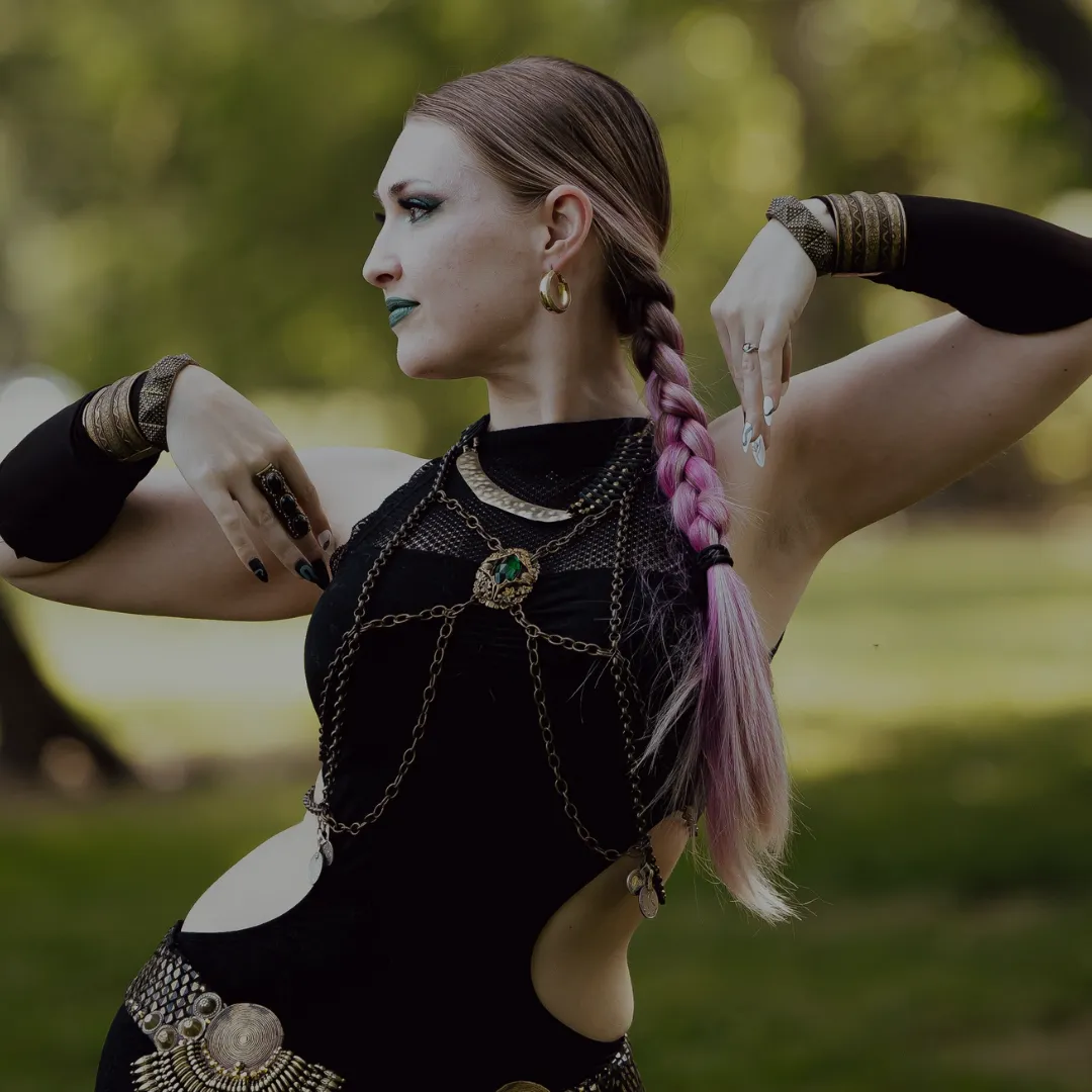 Izzy dark fusion dancer with black costume dress and braided hair