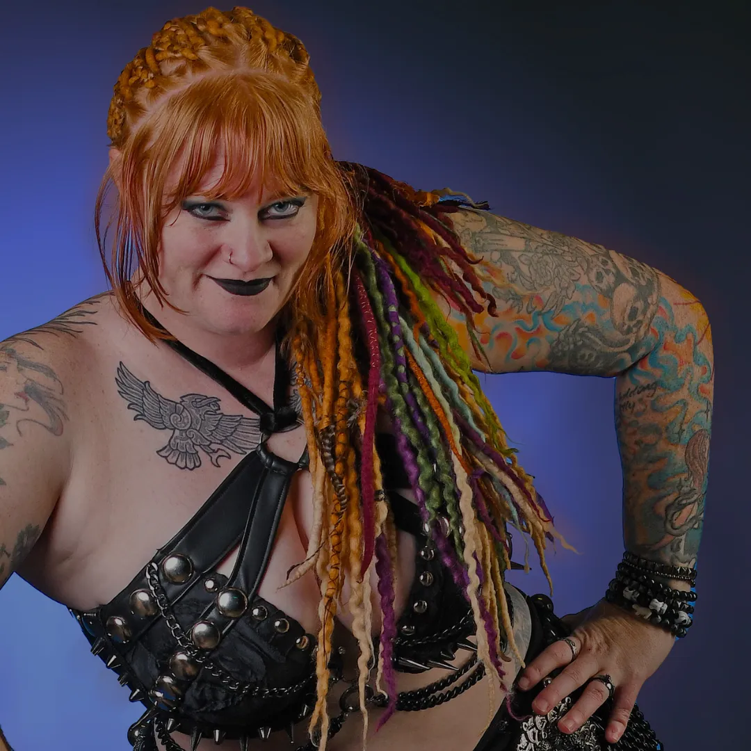 Daewen confident dancer pose with dreadlocks, black costume, and tattoos
