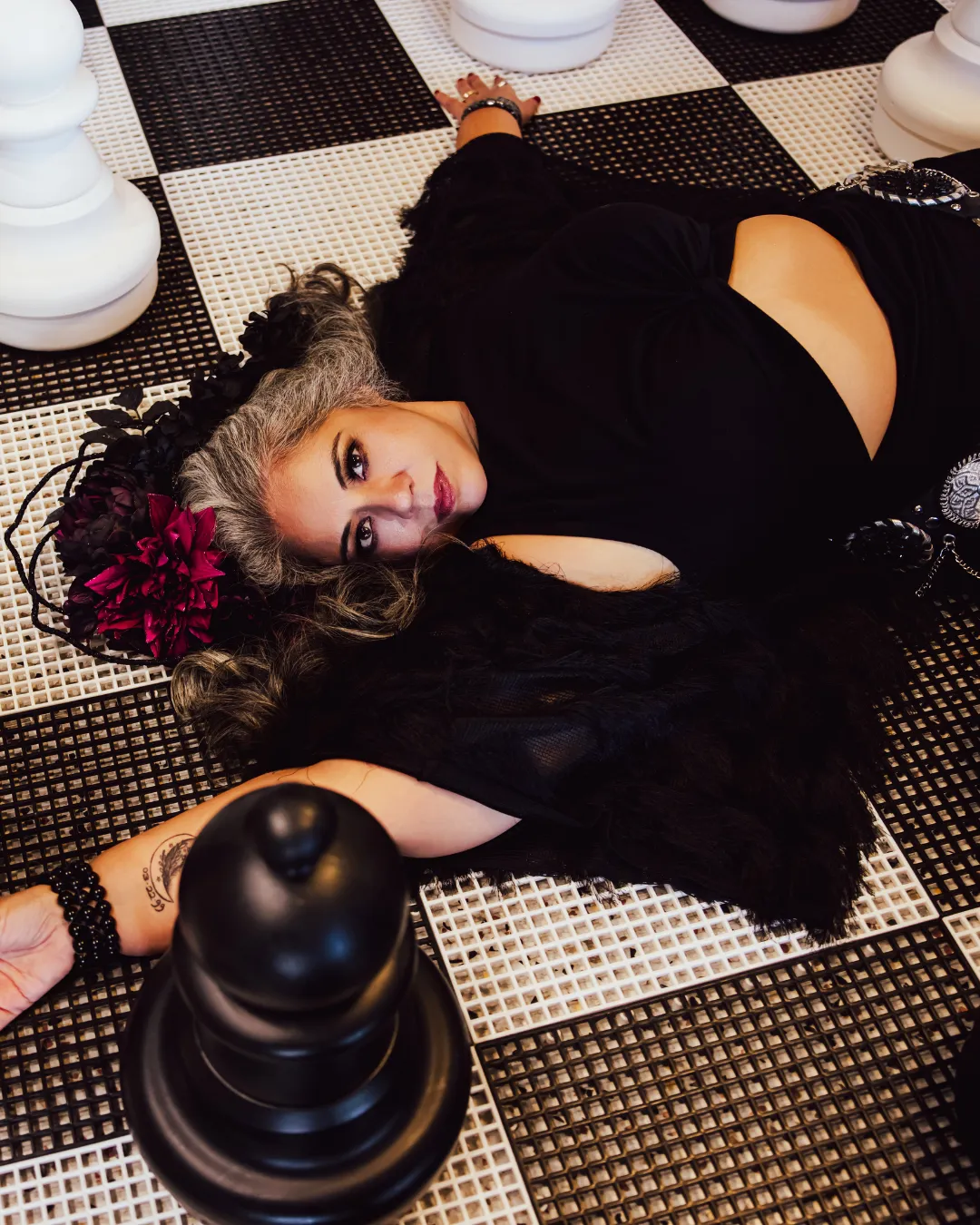 Lillith Hellhouse gothic pose on chessboard