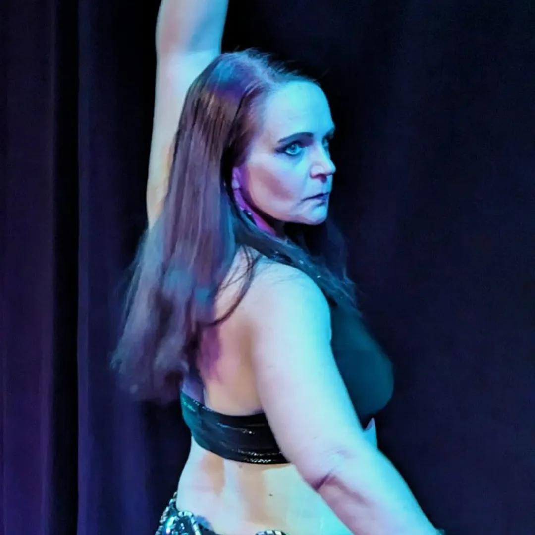Aeryn dark fusion dancer posed for performance in black costume