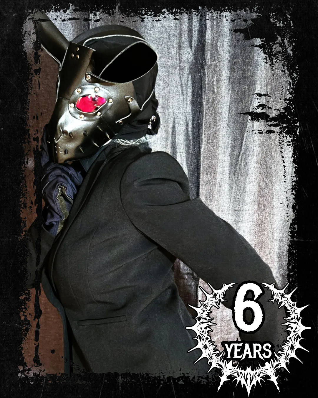 Lillith Engur in a black suit and rabbit mask