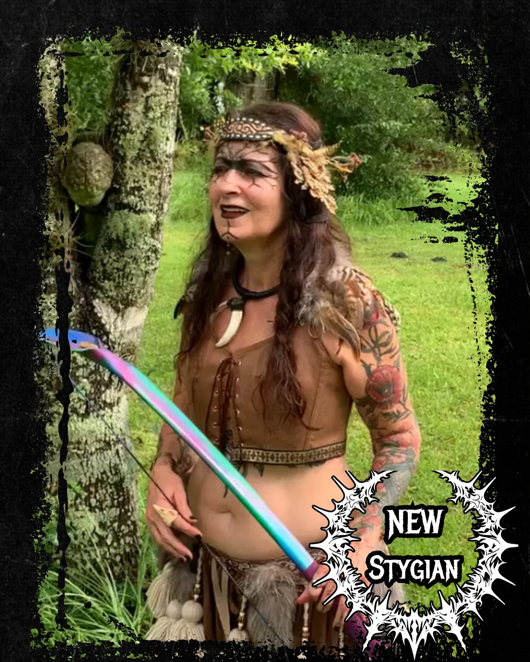 Kristina fusion dancer in faire costume with leather, feathers, bone and carrying a bow
