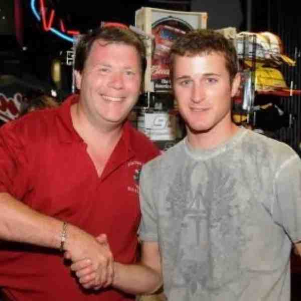 Two men, the owners of Picture This Video, shake hands while looking at the camera