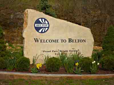 A close up picture of the stone with a sign that says Welcome To Belton
