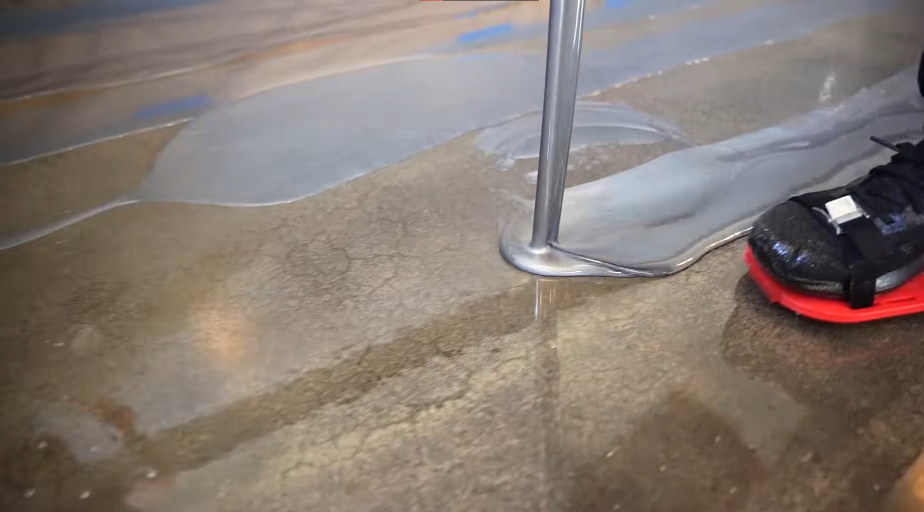 silver epoxy paint poured on reflective concrete floor